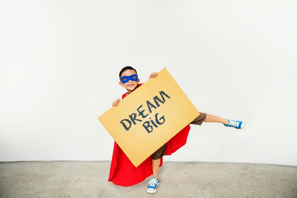 boy holding asign with dream big 53876 138097